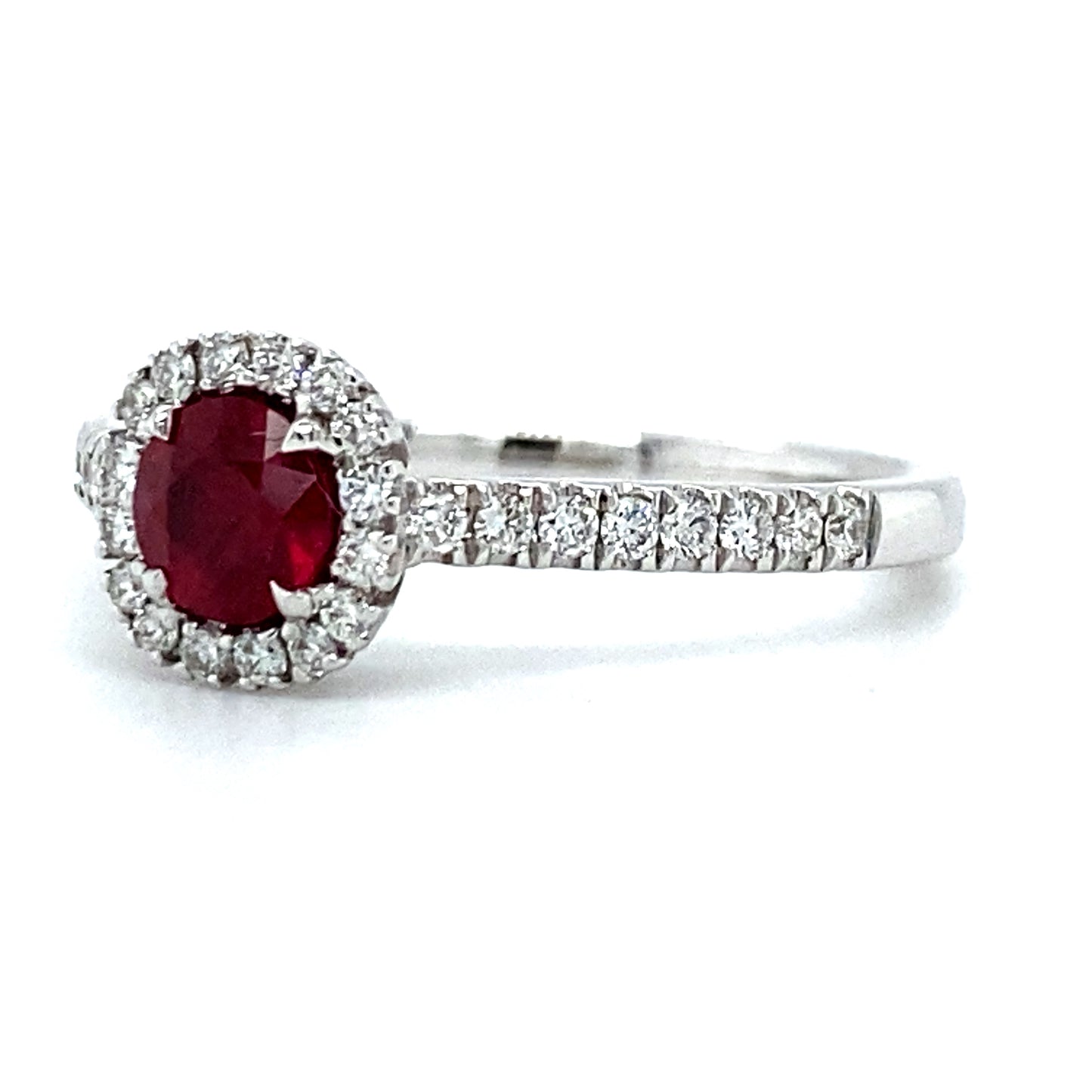 18 karaat witgouden rozet ring, bezet met 1 robijn van 0.51 crt die omringd is door kleinere briljant geslepen diamanten, die ook doorlopen in de ringband. De 32 diamanten hebben een totaalgewicht van 0.27 crt, kleur top wesselton kwaliteit vs model R 8946