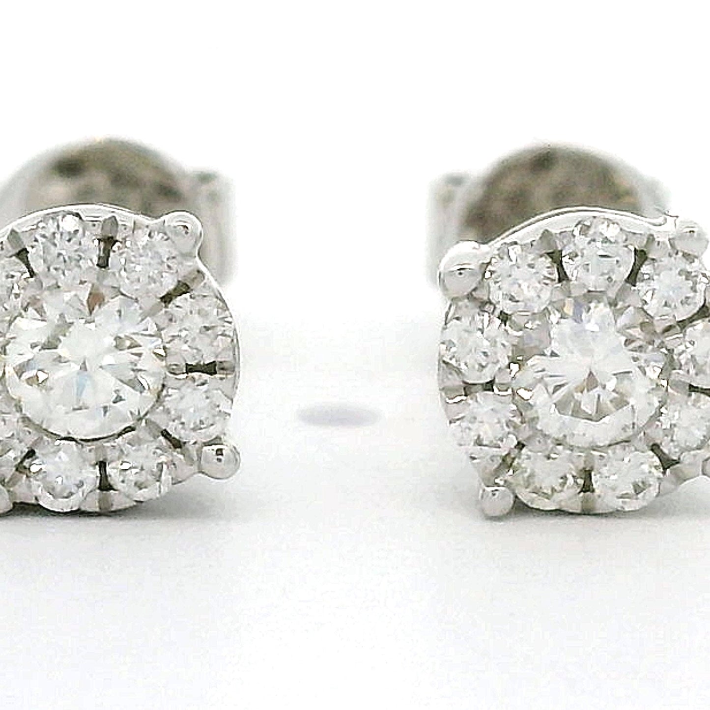 14 karaat wit gouden rozet oorbellen. Bezet met 2 briljant geslepen diamanten met een totaalgewicht van 0.14 crt en 18 kleinere briljant geslepen diamanten met en totaalgewicht van 0.12 crt Kleur G Zuiverheid: VS1 Zetting: Ø 5 mm Model: O 4399