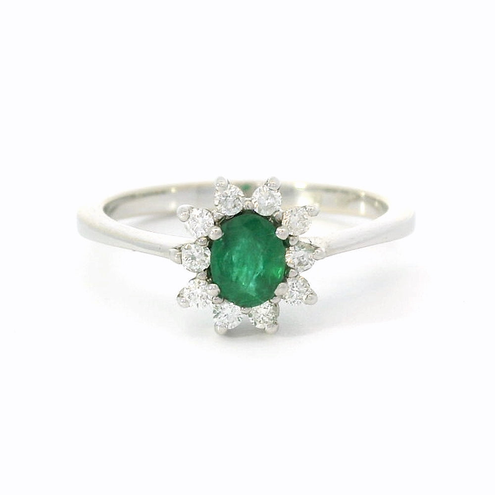 14 karaat wit gouden rozet ring van 2. gram en 1 tot 2 mm breed. Bezet met 1 ovaal geslepen smaragd van 0.33 crt en 10 briljant geslepen diamanten met een totaalgewicht van 0.18 Kleur H Kwaliteit: SI Zetting: 10 x 9 mm Model: R 10167