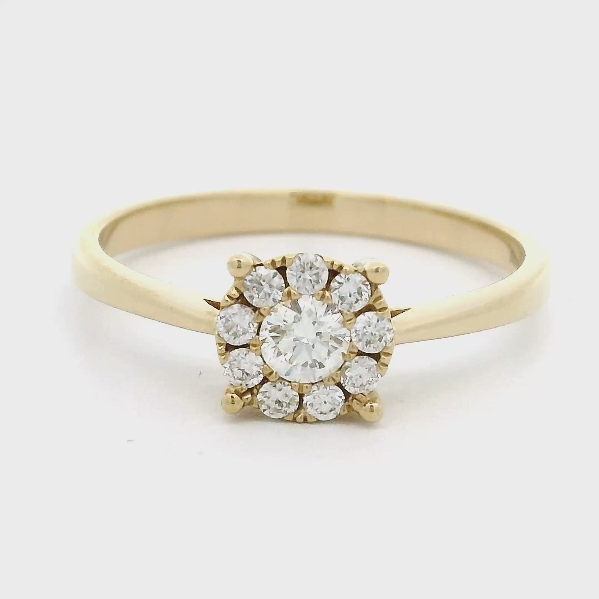 14 karaat geel gouden rozet ring uit de Invisible zetting collectie. Bezet met 1 briljant geslepen diamant evan 0.15 crt en 9 kleinere briljant geslepen diamanten met een totaalgewicht van 0.14 crt Kleur: G Zuiverheid: VS Zetting: Ø 7 mm